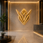 Luxury lobby with a prominent logo on the wall, potted plants, and a reception desk.